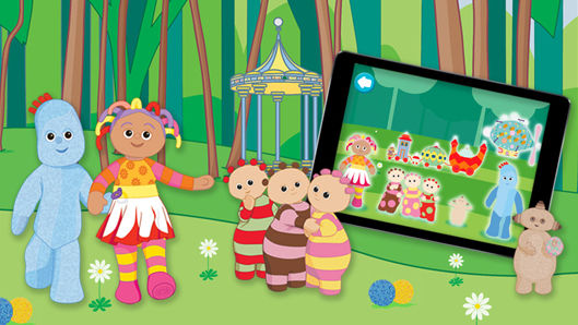 A bunch of characters in a green park standing beside a large tablet.